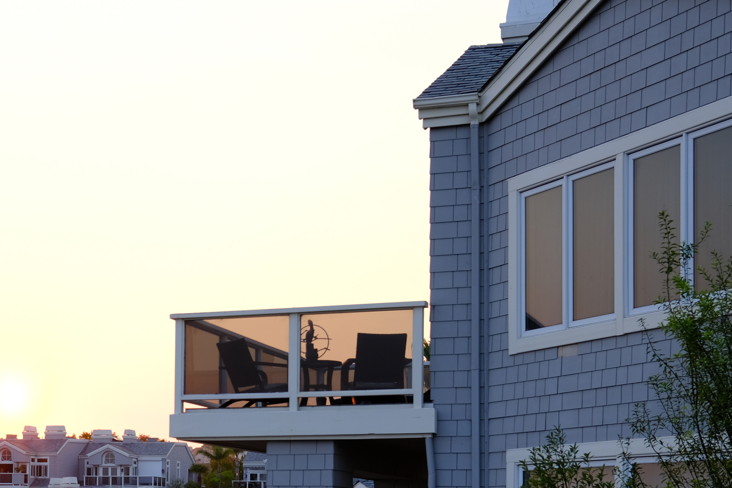 Clean tinted balcony windows of a condo at sunset.
