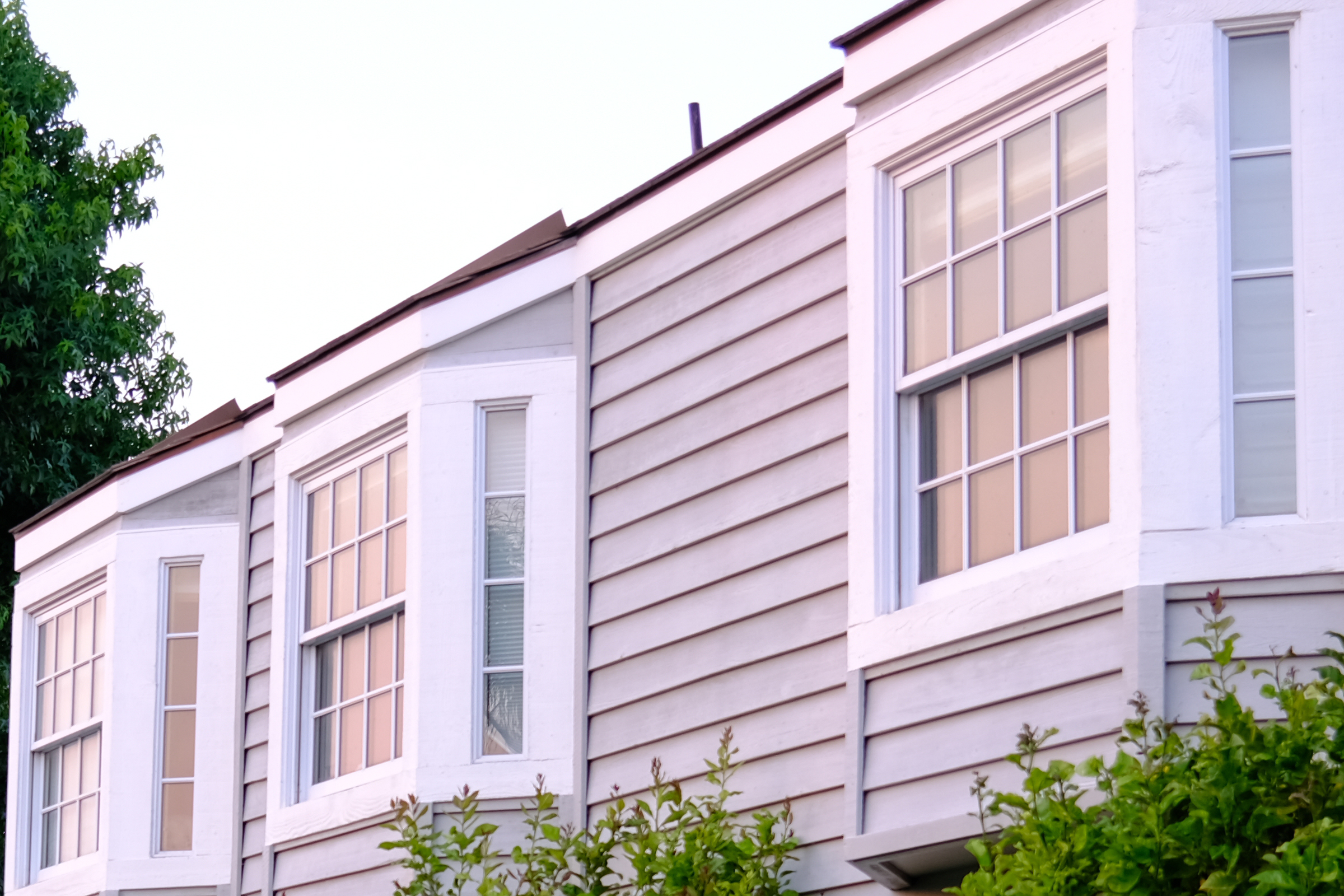 Clean second-story windows of a craftsman home.